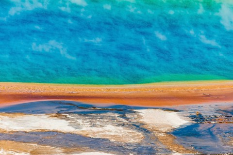 Colored mineral deposits at the edge sr steaming hot spring