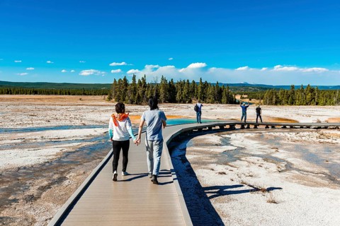 Two tourists on a jetty in the thermal area