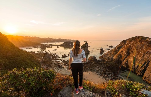Young woman looking into the sunrise