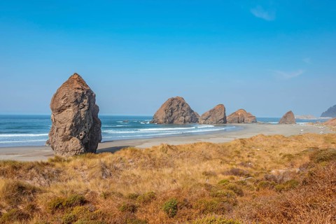 View over sandy beach and large monolithic rocks