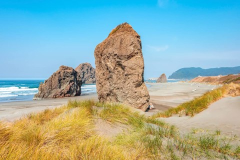 View over sandy beach with large monolithic rocks