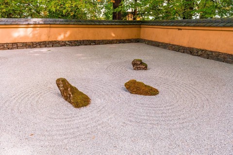 Japanese garden with gravel surface as symbol for water