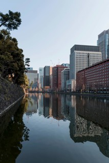 High-rise buildings reflected in a canal