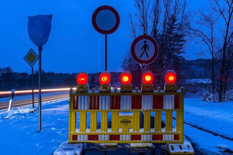 Illuminated snow barrier in winter at dusk