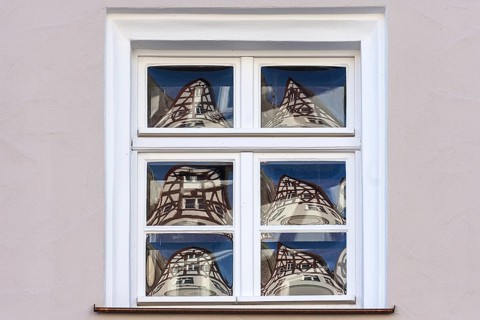 Half-timbered houses reflected in glass windows