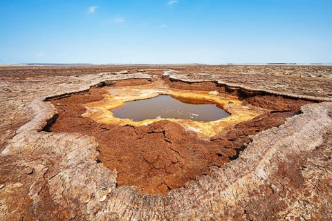 Salt lake with geothermal spring and petrified salt crystals