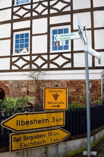Road sign German Wine Route in front of half-timbered house in Leinsweiler