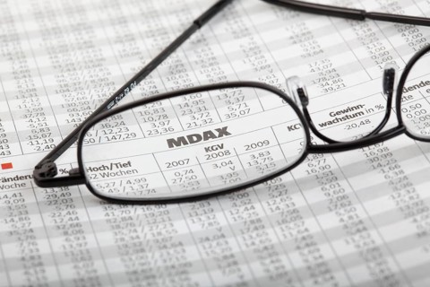 Reading glasses lying on newspaper