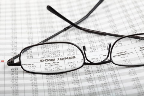 Reading glasses lying on newspaper