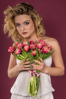 Young woman posing with bouquet of flowers