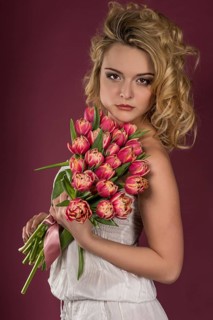 Young woman posing with bouquet of flowers