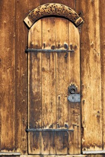 Door with iron fittings and wooden relief