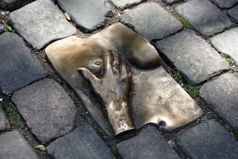 Bronze relief in cobblestone