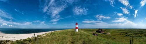 Beach panorama at the elbow with lighthouse