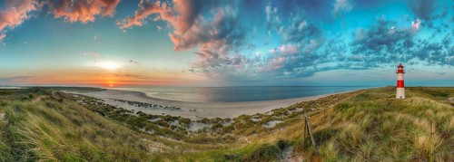Panorama at the elbow with sunset and lighthouse