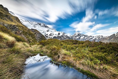 Mountains reflected in small mountain lake