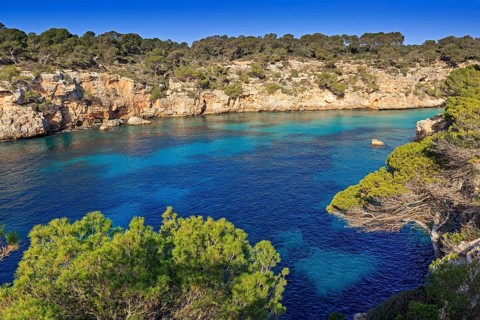 The turquoise waters in the bay of Cala Pi