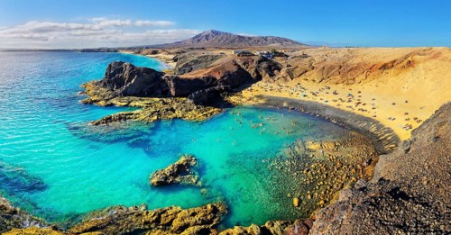 Sandy beach Playa del Papagayo with clear turquoise water