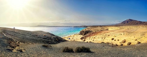 Sandy beach and rocky coastline with turquoise waters of Playa del Papagayo
