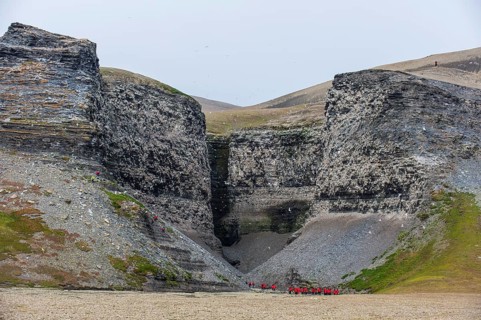 Tourists at the cliffs at Diskobukta with black-legged Kittiwakes (Rissa tridactyla)