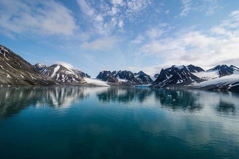 Mountains reflecting in the water in the Magdalenefjorden
