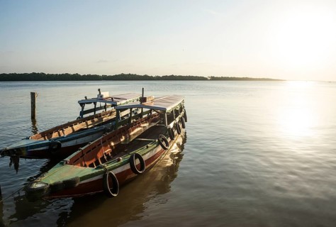 Boats at sunset on the Suriname river near Paramaribo