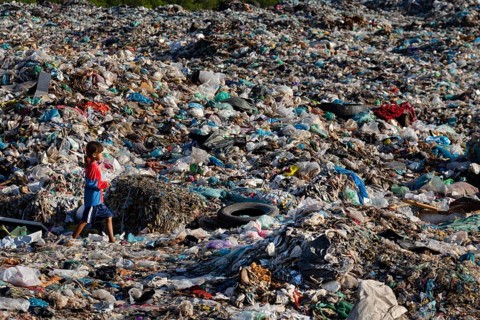 Little girl in garbage dump
