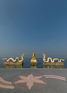 White Naga statues with golden Chedi on the shore of Lake Kwan Phayao