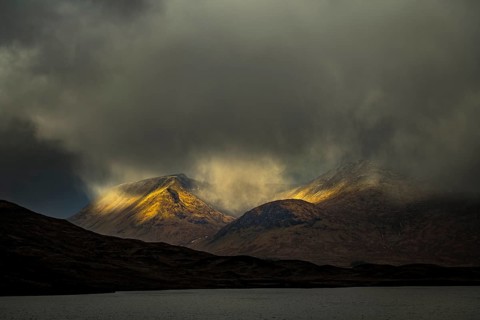River Ba with mountain peaks of Meall aÂ´Bhuiridh and Clach Leathad in the background and dramatic clouds