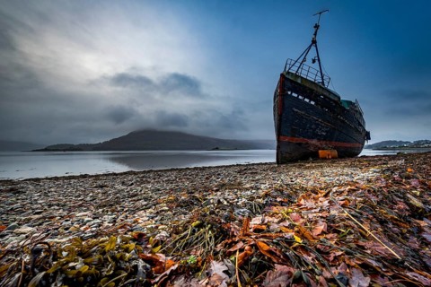 Ship wreck at Loch Eil with coloured leaves in the foreground