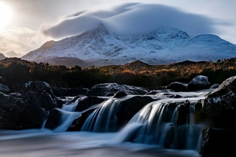 Waterfall of AltDearg Mor with snow-covered peaks of Marsco and Sgurr Nan Gillean