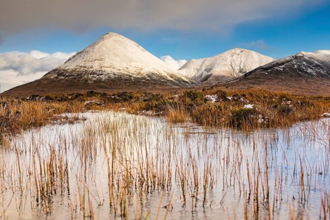 Moor landscape with snow-covered peaks of the Cullins Mountains in Highland Landscape