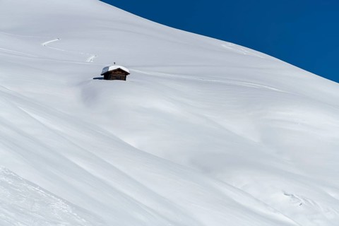 Small mountain hut in winter landscape