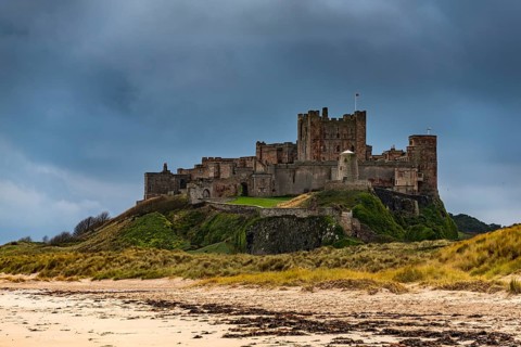 Sandy coast at low tide with Bamburgh Castle