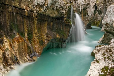Waterfall on the emerald green wild river Soca