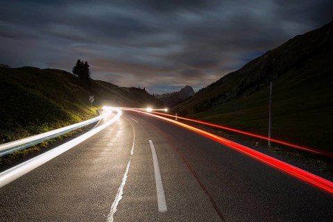Pass road at night with light streaks from cars on Hochtannbergpass