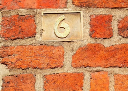 Old golden house number plate