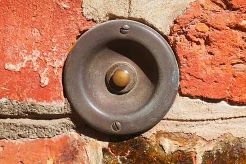Old bell on a brick wall in historic centre of Luneburg
