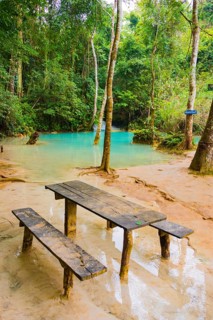 Wooden table in turquoise water