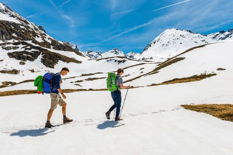 Two hikers walk over snowfield