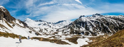 Two hikers walk over snowfield