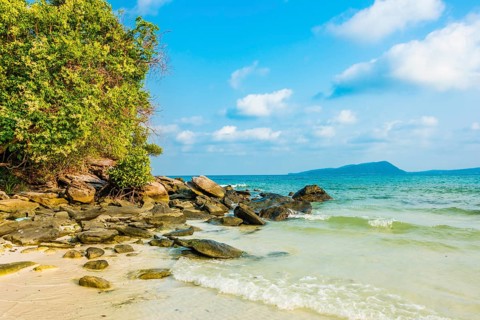 Idyllic sandy beach with rocks