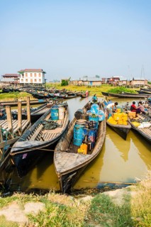 Wooden boats with old oil barrels in the harbor