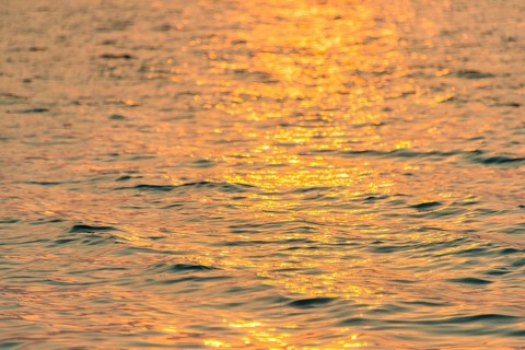 Sunlight reflecting on sea at sunrise from Koh Tui Beach