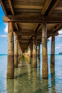 Pier on beach with turquoise water at Saracen Bay on Koh Rong Sanloem island