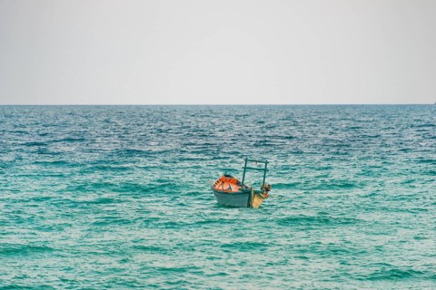 Traditional long-tail boat in turquoise sea