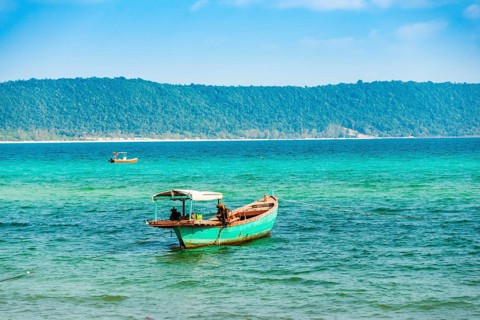 Traditional long-tail boat in turquoise sea
