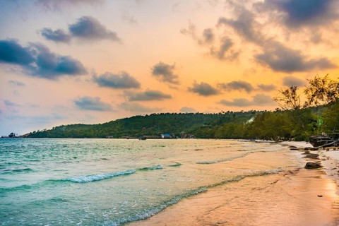 Idyllic sandy beach with turquoise water at sunset