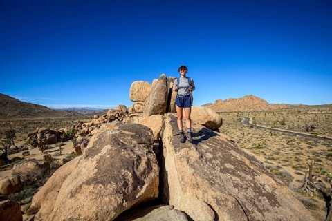 Young woman on boulder