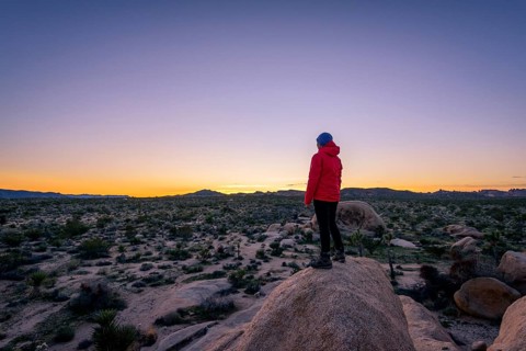Young woman standing on granite rocks